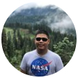 A man in NASA shirt outdoors