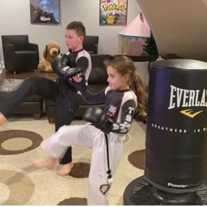 A boy and a girl martial arts training at home