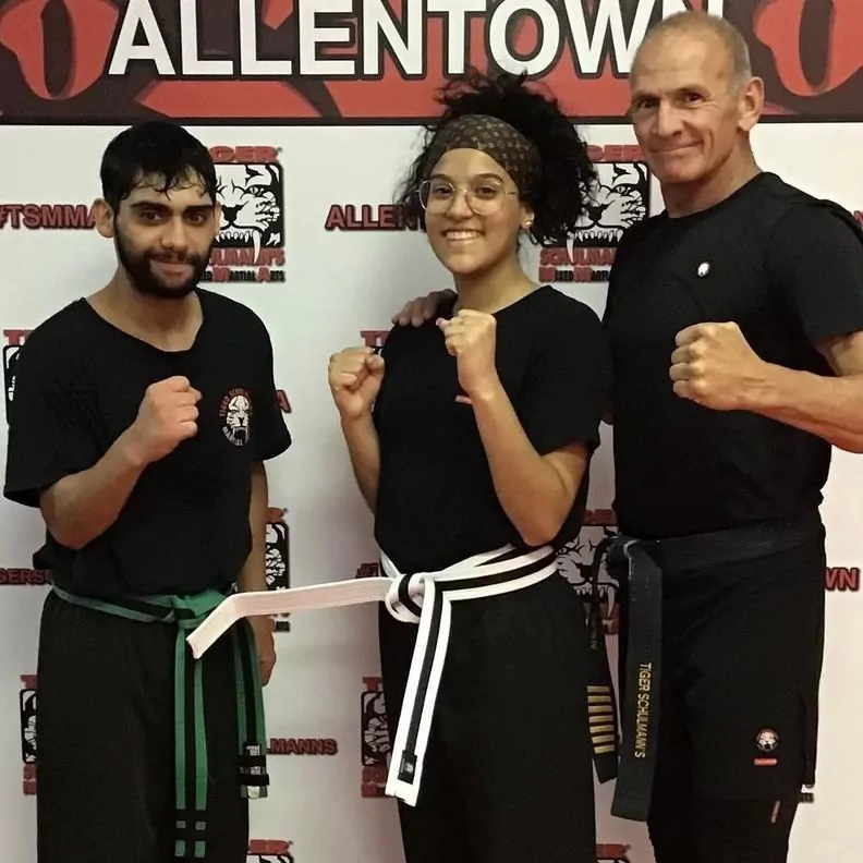 Shihan James Simpson with young male and female fighters