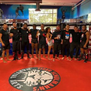 A group of male and female MMA fighters posing at Tiger Schulmann's Bayridge
