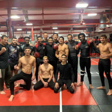 A group of male MMA fighters posing at Tiger Schulmann's Bayridge