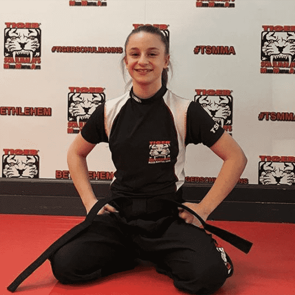 A girl sitting on her knees at martial arts training in Bethlehem