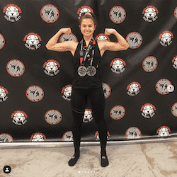 Girl with medals flexing muscles