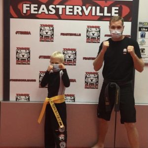 Adult fighter and a boy at Tiger Schulmann's in Feasterville