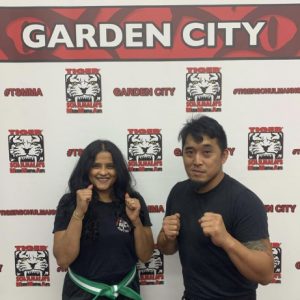 A man and a woman posing in fighting stance at Tiger Sculmann's Garden City