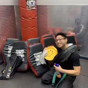 A boy next to kickboxing equpment at Tiger Schulmann's Garden City