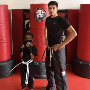 A kid and a martial arts instructor at Tiger Schulmann's Glendale