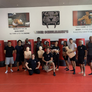 A group of adults with martial arts instructors at Tiger Schulmann's Glendale
