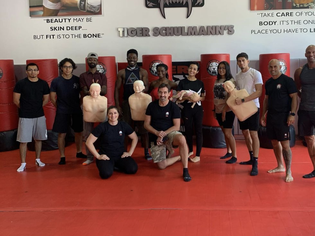A group of adults with martial arts instructors at Tiger Schulmann's Glendale