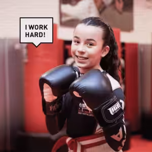 A girl with kickboxing gloves at Tiger Schulmann's Glendale