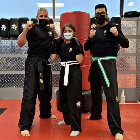 Two adult fighters and a girl at Tiger Schulmann's Hauppauge