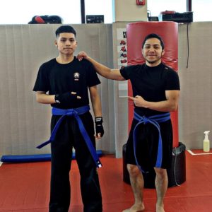 Two young fighters with blue belts at Tiger Schulmann's Hauppauge