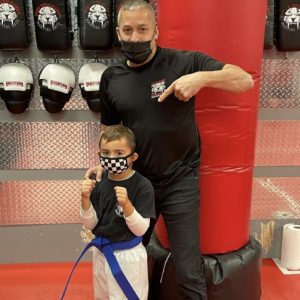 A boy fighter with his instructor at Tiger Schulmann's Hauppauge