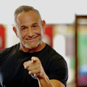 Martial arts expert pointing finger at objective