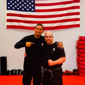 Two martial arts fighters in front of an american flag at Nanuet