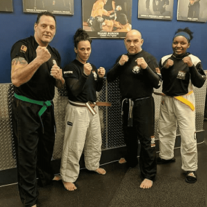 Sensei Jose Montes and two male and one female instructor at Tiger Schulmann's