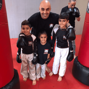 Martial arts instructor with three kids at Tiger Schulmann's New Dorp
