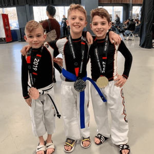 Three boys posing with medals in Seaford
