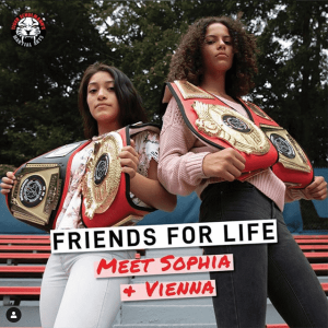 Girls Sophia and Vienna posing with their championship belts in Stamford