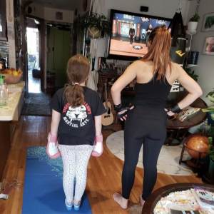 A woman and a little girl working out at home