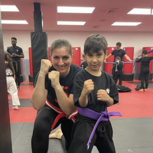 A boy and a lady instructor at kids training in Rego Park