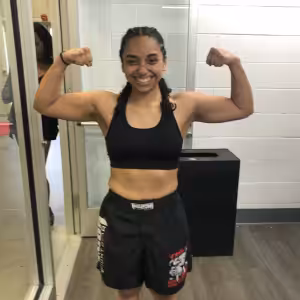 Girl showing off her muscles at Tiger Schulmann's Rockville
