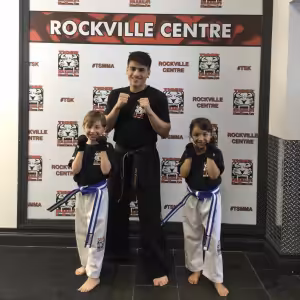 A boy and a girl with their instructor at Tiger Schulmann's Rockville