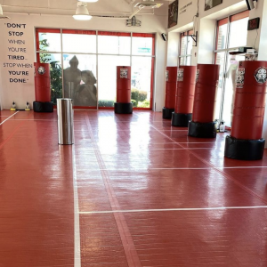 Tiger Schulmann's Seaford gym with red floor and red punching bags