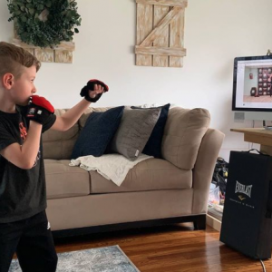 A boy practicing martial arts at home in Smithtown