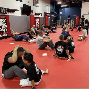 Martial arts workout kids and adults together in Wayne