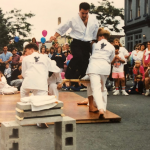 Martial arts fighters performing on the street with crowd
