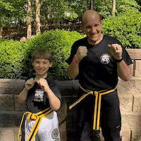 Martial arts fighter and a boy outdoors in Wayne