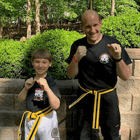 Martial arts fighter and a boy outdoors in Wayne