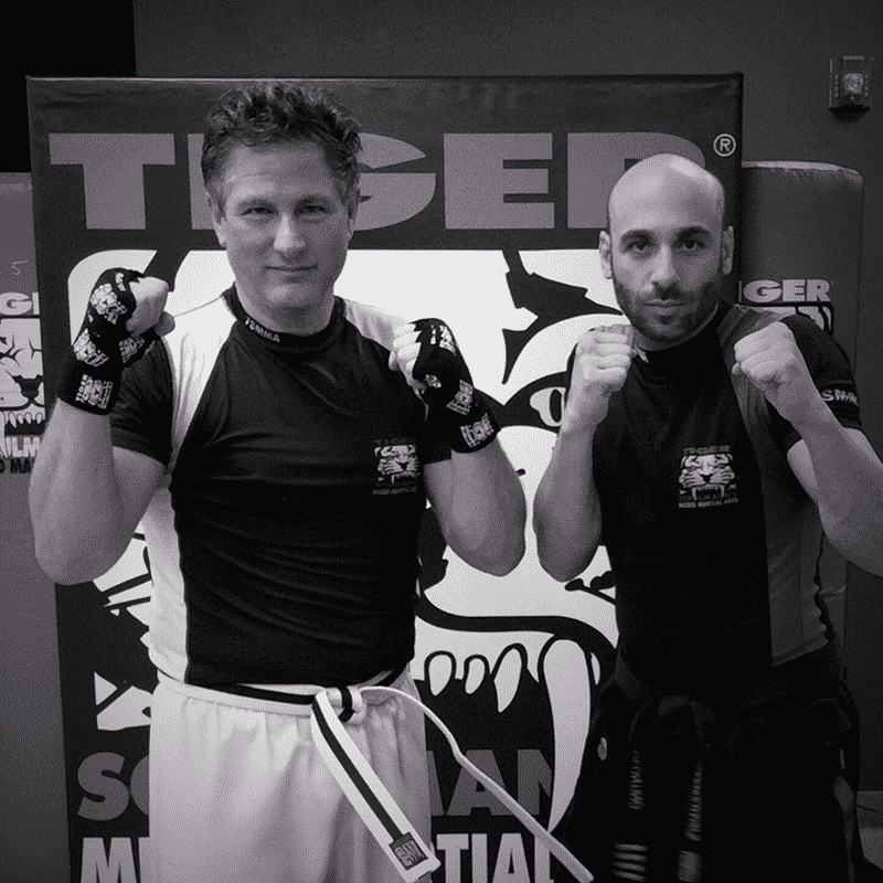 Two adult MMA fighters with fists up