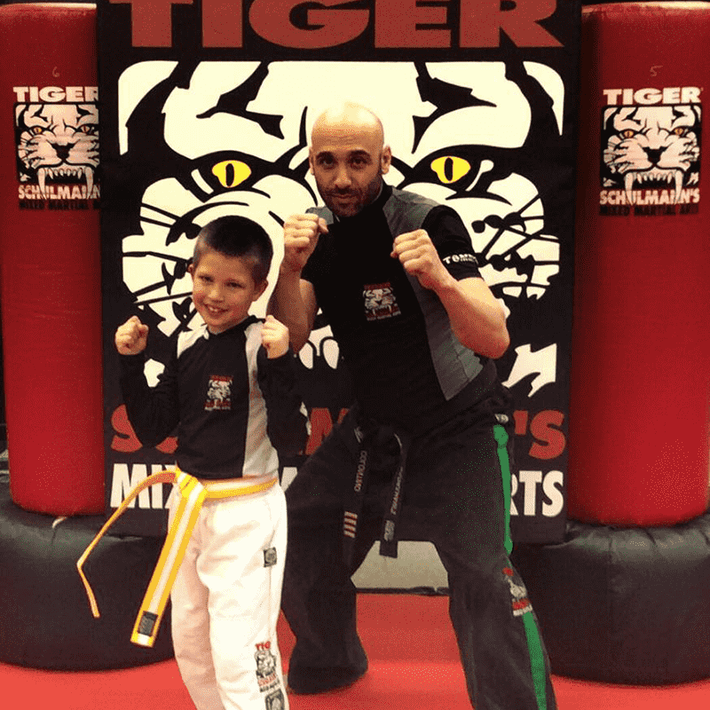 Sensei and a boy in a boxing stance