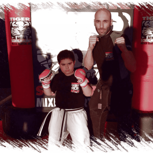 Sensei and a boy in a boxing stance