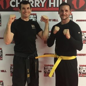 Two MMA fighters with fists up at Tiger Schulmann's in Cherry Hill