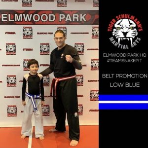 A martial arts instructor with a boy