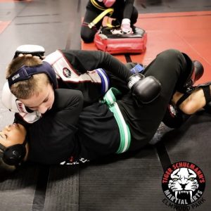 Two boys grappling during a martial arts tournament