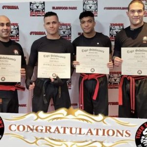 Four martial arts fighters showing their certificates