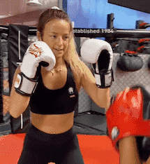 A woman with fists up sparring