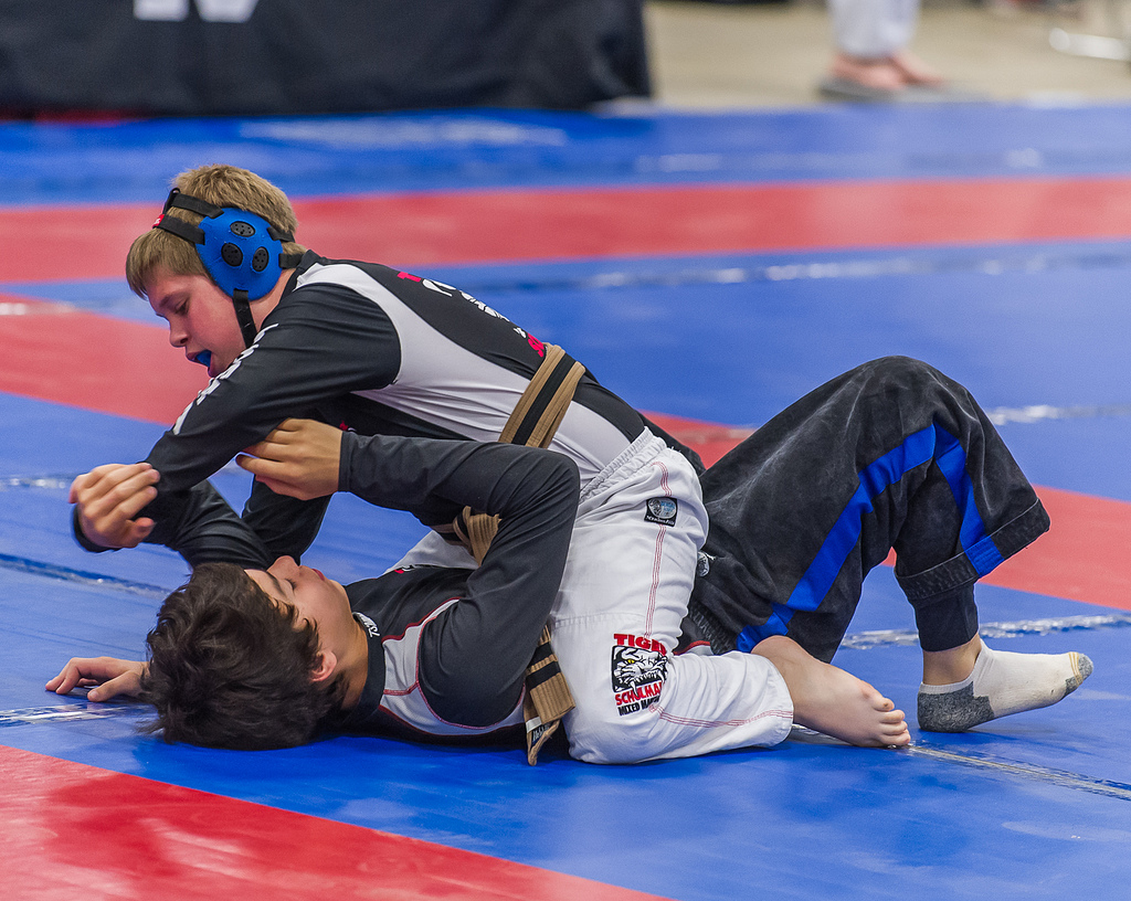 Two boys grappling during a martial arts tournament