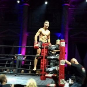 Martial arts fighter standing on the ropes of the ring in Hoboken