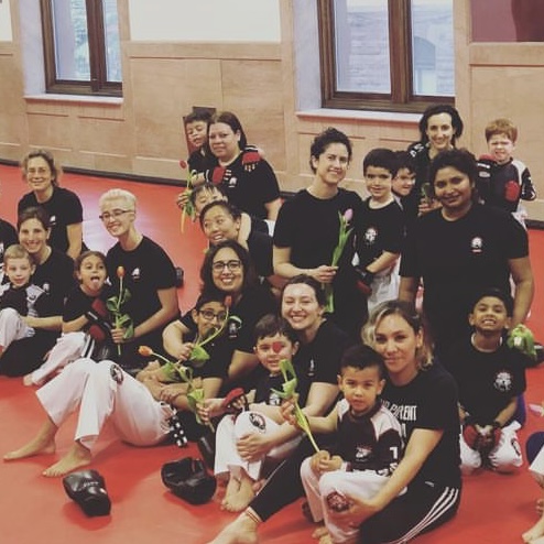 Kids and their instructors with flowers at Tiger Schulmann's in Hoboken