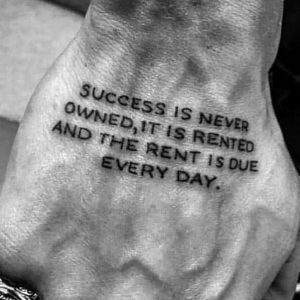 Motivational quote tattooed on a hand