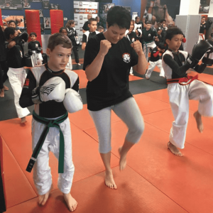 Kids exercising with female instructor at Tiger Schulmann's in Morris Plains