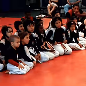 Kids sitting on the floor of the Tiger Schulmann's gym during training