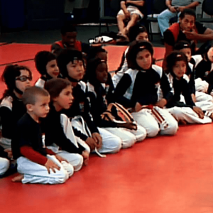 Kids sitting on the floor of the Tiger Schulmann's gym during training