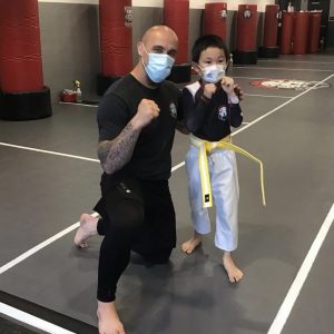 Martial arts instructor and a boy with raised fists at Tiger Schulmann's in Princeton