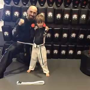 Martial arts instructor and a boy with raised fists at Tiger Shulmann's in Princeton